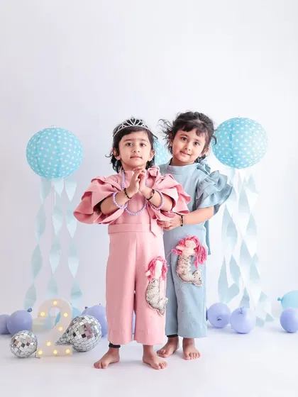 Double the fun! We have plenty of experience with twins and sibling photoshoots. We make sure to capture both their shared bond and their individual personalities, like in this adorable second birthday session.