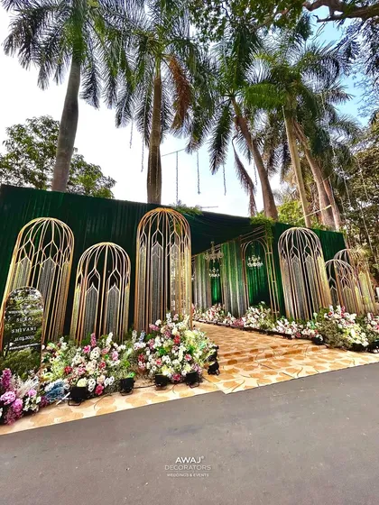 The entrance as seen during the day, highlighting the beautiful palm trees and the natural setting.