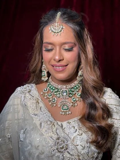 A close-up of the makeup for this unique white bridal look. I used soft pink and green tones on the eyes to match her jewelry, keeping the skin fresh and dewy.