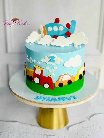 Revving up the fun with a slice of sweetness. This cake is perfect for a transportation lover, featuring a train, cars, and an airplane.