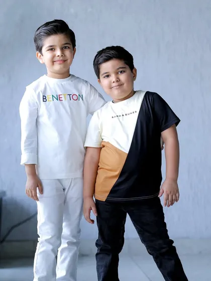 A happy portrait of two brothers at a birthday party, showcasing the bond between siblings.