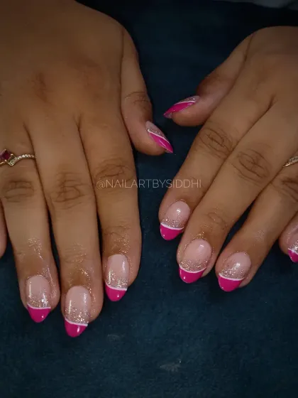 A fun twist on the French manicure, with a bright pink tip, a fine silver glitter line, and a crisp white accent line.