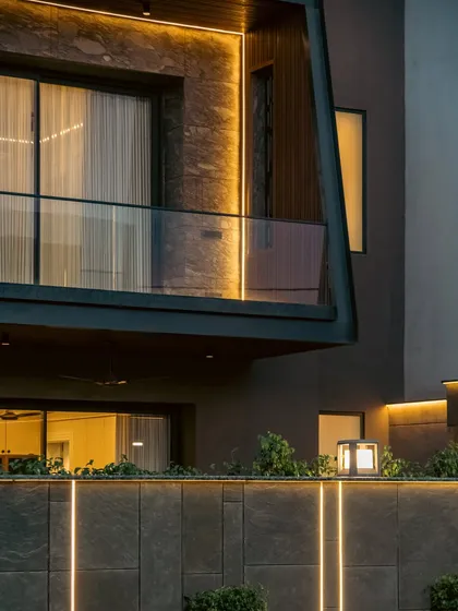 A garden's story continues after sunset. We use strategic lighting to transform the landscape at night, highlighting the textures of stone walls and the shapes of foliage. This not only enhances safety and usability but also creates a magical, dramatic atmosphere that gives the home a completely new character after dark.