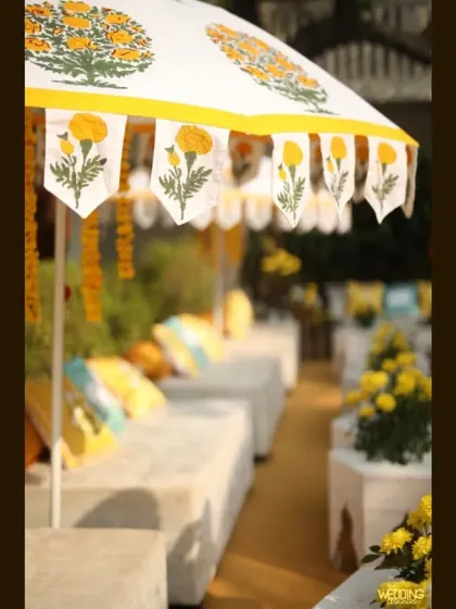 For a winter Haldi, we created comfortable lounge seating under custom block-printed umbrellas, allowing guests to soak up the sun in style.