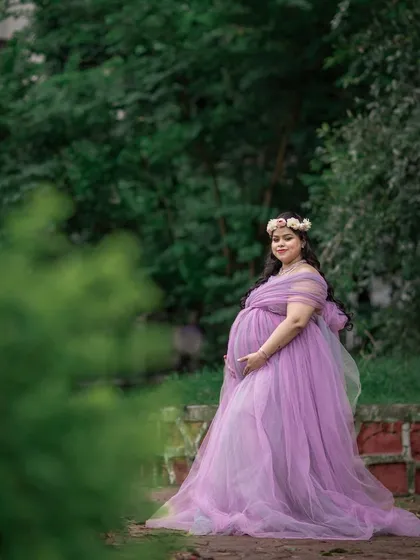 Soft and romantic, this lavender tulle gown gives an ethereal, fairy-tale feel to your photos. The off-shoulder design is flattering and highlights the beauty of motherhood.