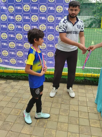 The walk of a winner. A Bravo U8 player on his way to receive his medal after a great tournament.