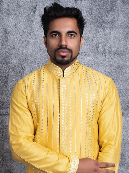 A close-up portrait in our canary yellow kurta. This view highlights the detailed gota embroidery along the placket and collar, perfect for festive occasions.