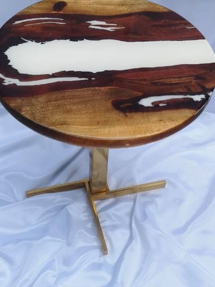 Another example of a classic river table design. This piece uses white resin to create a stark, beautiful contrast with the warm tones of the wood.