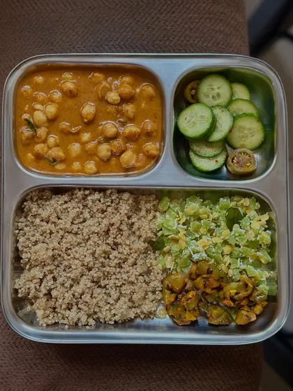 This plate features quinoa, channa masala, and a mix of sautéed vegetables. It's a perfect example of a plant-based, high-protein, and gluten-free meal.