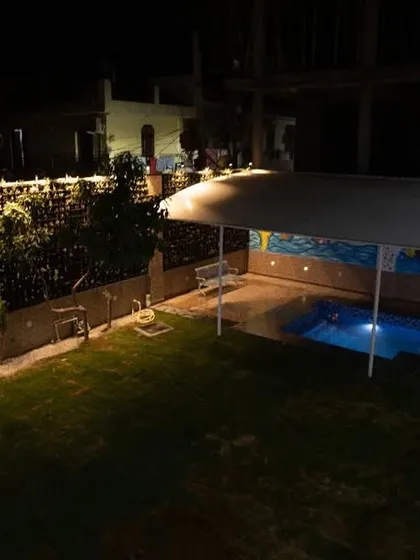 An evening view of our park and pool area. The space is beautifully lit, providing a safe and pleasant environment for dogs after sunset.