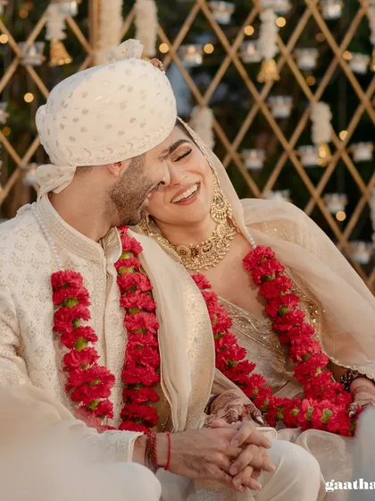 A joyful, candid moment of the couple sharing a laugh during their intimate wedding, surrounded by the warmth of their loved ones.