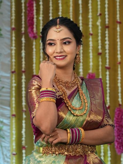 Harshitha looking elegant and happy. The makeup is designed to be timeless and classic for this important family milestone.
