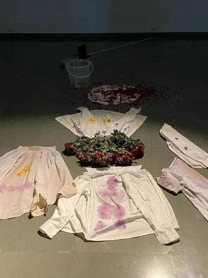 The culmination of the live performance, where flower-stained fabrics are arranged on the floor. The artwork is the process itself, and what remains is a trace of the actions performed.