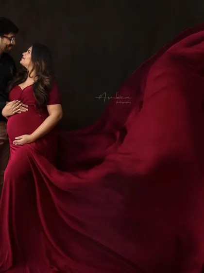 A romantic couple's shot incorporating the dramatic fabric toss. This image combines the intimacy of a couple's portrait with the dynamic energy of the flowing gown.