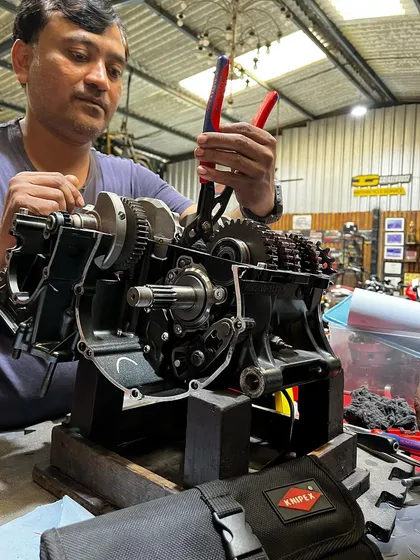 One of our mechanics, Arif, meticulously working on the Yamaha YZF-R6 engine rebuild, using precision tools to ensure every component is perfect.