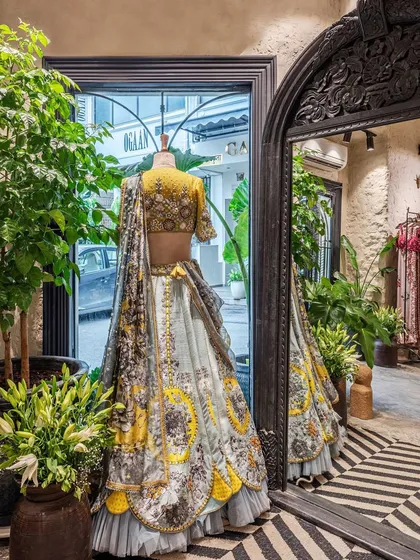 Our design philosophy for retail spaces is to let the product take center stage. Here, a neutral backdrop of lime-plastered walls and carefully curated lighting ensures this stunning designer lehenga is the main focus, demonstrating how thoughtful interior design can enhance the merchandise.