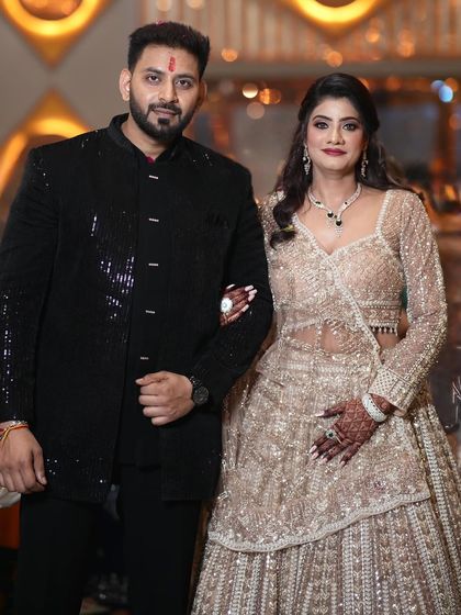 My engagement bride Shruti with her partner. Her sequined lehenga is paired with a soft, glowing makeup look perfect for the occasion.