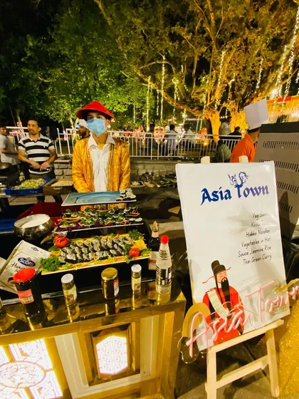 I bring the world to your plate with themed global cuisine counters. This 'Asia Town' station, complete with fresh sushi and other delicacies, is always a favorite among guests.