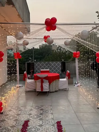 Another view of the romantic terrace dining setup, showing the rose petal path leading to the beautifully decorated table for two.