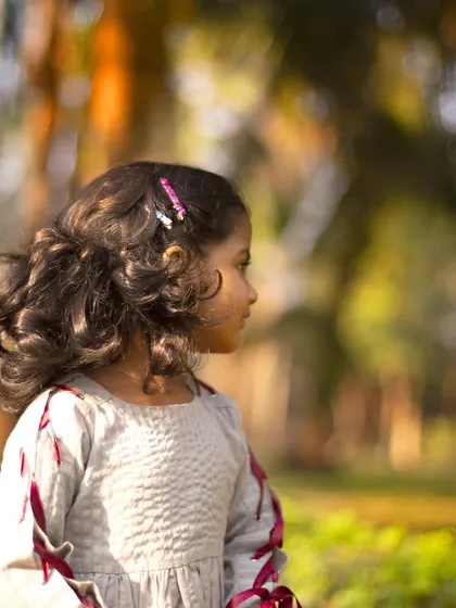 A thoughtful profile shot from her third birthday. These images are not just pictures; they are a reflection of who she is at this age, a precious memory for her family.