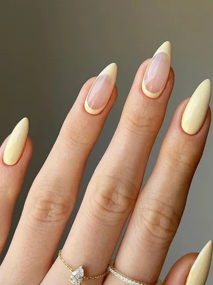Here is a French manicure with a soft, buttery yellow tip on a sharp almond shape. It’s a subtle, stylish way to incorporate a bit of color into a classic design, perfect for the spring and summer months.