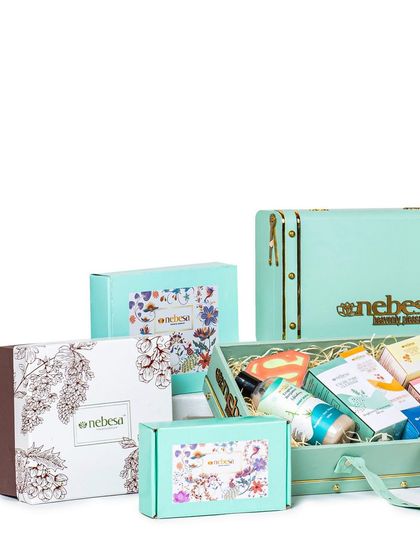 My custom gift boxes come in all shapes and sizes. This image showcases a variety of my packaging options, from elegant trunk boxes to smaller, beautifully printed cartons, all designed to make your gift feel extra special.