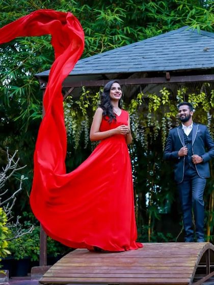 The long trail of this red flying gown looks stunning as it billows in the wind. It's a versatile piece that allows for many creative shots during a pre-wedding shoot.