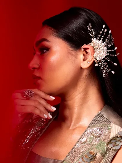 A festive season drop. This model looks fierce and elegant in our pearl fan earcuff, a statement piece perfect for making an entrance this festive season.