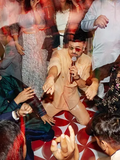 The party doesn't stop! Candid moments of guests and performers taking over the dance floor with the groom.