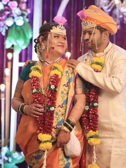 The groom with his arm around his bride, a sweet and simple portrait that captures their new bond after the wedding ceremony.