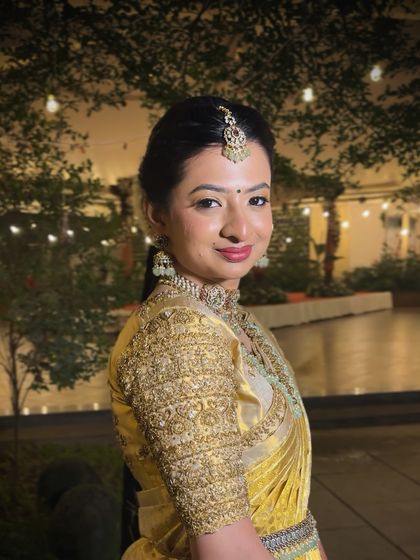 A beautiful portrait of this bride in her gold Kanjivaram, with subtle makeup and a bold lip creating a stunning contrast.