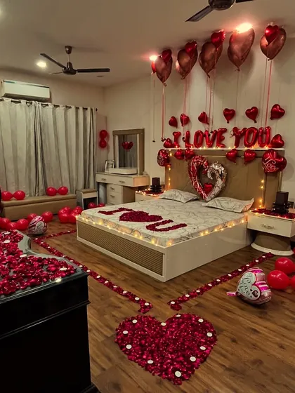 For the ultimate romantic gesture, we transform entire rooms into a haven of love. This surprise setup includes a pathway of rose petals, hundreds of red balloons, "I LOVE YOU" foil letters, and soft lighting to create an unforgettable anniversary or proposal experience.