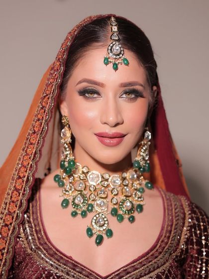 Elevating bridal beauty with a flawless makeup look. This image highlights the glowing skin and perfectly sculpted eyes that make a bride feel like royalty.