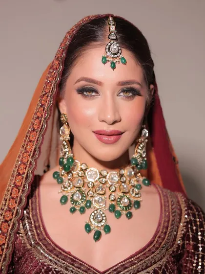 Elevating bridal beauty with a flawless makeup look. This image highlights the glowing skin and perfectly sculpted eyes that make a bride feel like royalty.