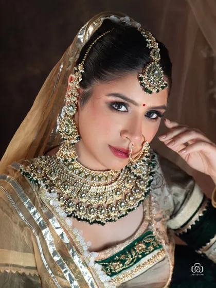 A close-up beauty portrait focusing on the intricate details of traditional Rajasthani jewelry and makeup. In the studio, I can control the light to perfectly highlight the craftsmanship of the accessories and the model's expressive features.