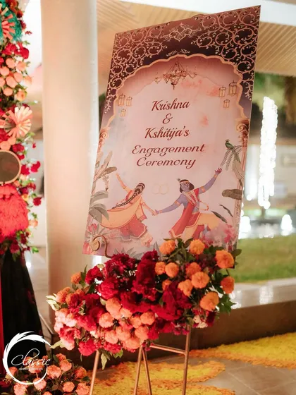 This welcome sign for an engagement ceremony features beautiful, traditional Indian artwork of Radha and Krishna, tying into the couple's story and the cultural theme of the event.