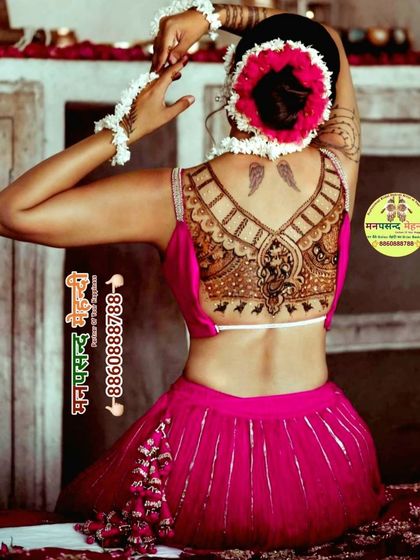 A unique and stylish back mehndi design featuring Lord Ganesha. This type of henna tattoo is a modern way to wear traditional symbols for special occasions.