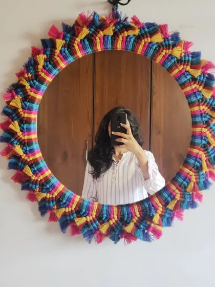 When you catch a glimpse of your potential, that's when passion is born. This vibrant, multicolored macrame mirror is a reflection of our love for bold and beautiful design.