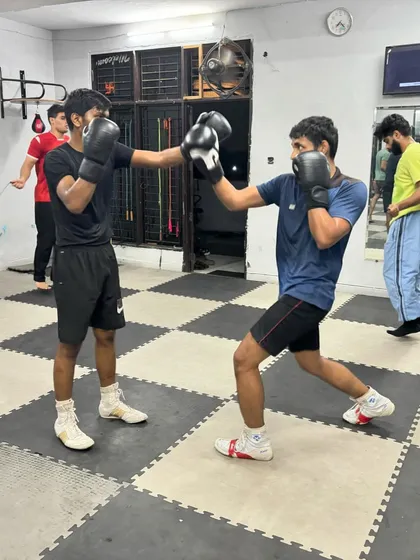 Two students working on their jab and defense. These fundamental partner drills are a constant part of our training regimen.