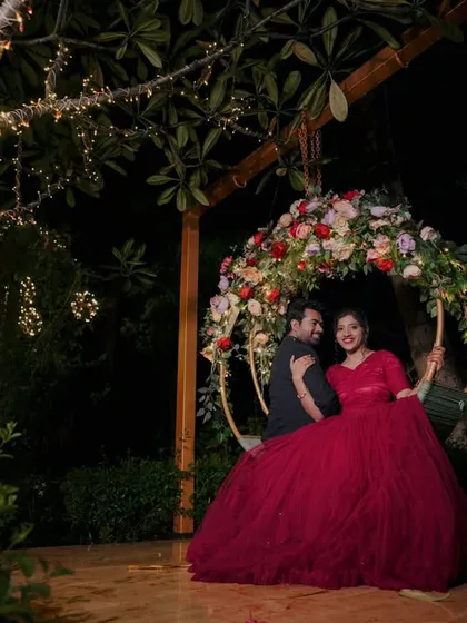 The floral swing at night is a perfect spot for a romantic and elegant photo, as shown by this beautifully dressed couple.