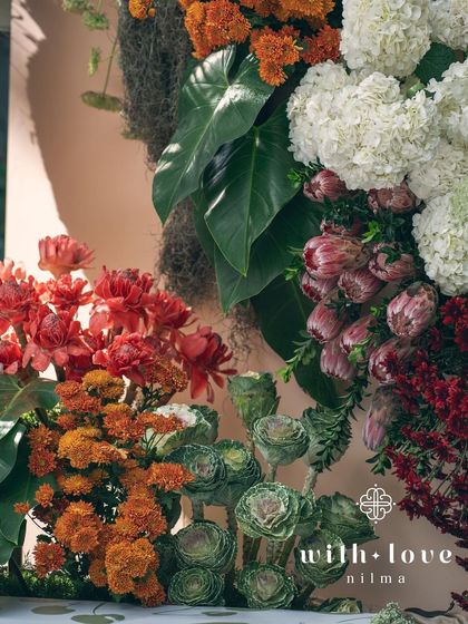 A close-up of the floral textures in our 'Garden of Gaia' design. We used a mix of marigolds, hydrangeas, proteas, and tropical leaves to create a rich, multi-layered, and visually stunning arrangement.