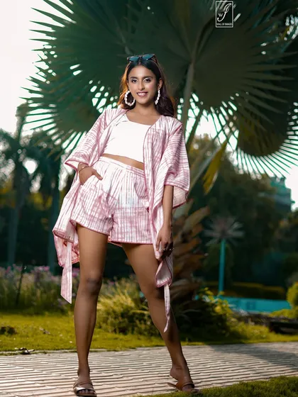 A relaxed and casual pose that shows off the full three-piece co-ord set, ideal for a vacation or summer fashion lookbook.