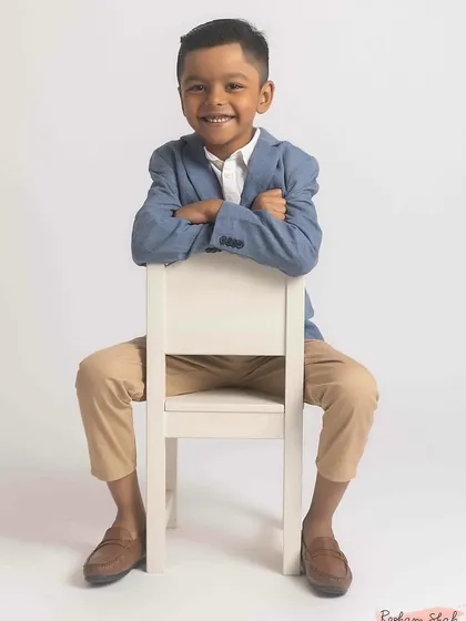 Even my work with kids has a touch of fashion. For this young man's birthday shoot, we went for a dapper, confident look against a clean white background. It’s about capturing their budding personality with a timeless, classic style.