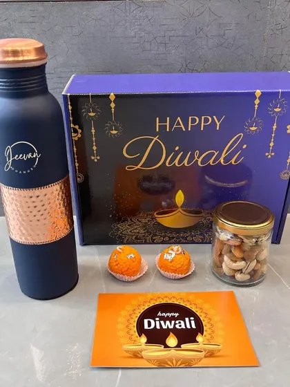 The complete Diwali gift box, showing the custom-designed packaging. This set with a personalized bottle, dry fruits, and sweets is ready to be gifted.
