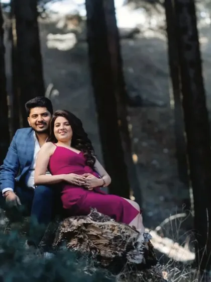 A couple posing in a dense forest, using the natural light and shadows to create a moody and intimate portrait.