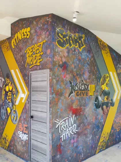 We bring high energy to fitness spaces with dynamic graffiti art. This project for One More Rep gym in Mangalore features motivational text and powerful figures to inspire every workout.