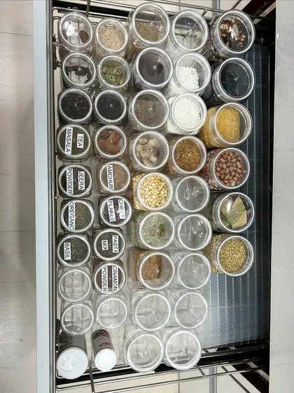 An overhead view of a spice drawer, showing how we use labels on the lids for quick identification. This is one of our favorite hacks for deep drawers.