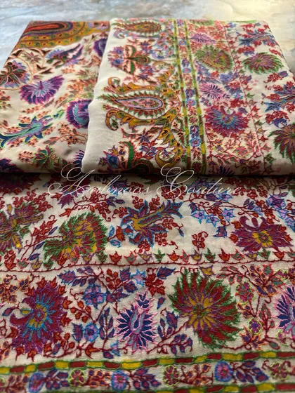 This composition shows the dupatta neatly folded, highlighting the crispness of the design and the masterful blend of painting and embroidery.