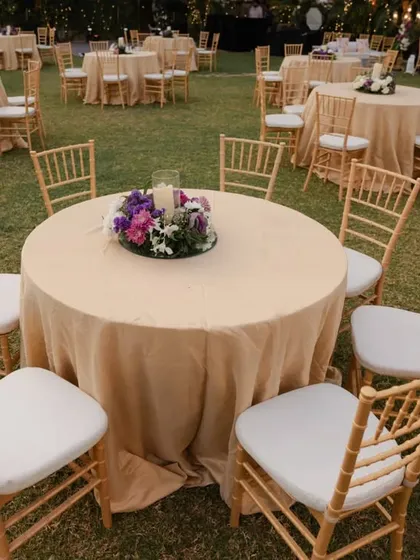 Simple elegance was the theme for this outdoor event. We used classic round tables with neutral linens and gold chiavari chairs, accented with a single, vibrant floral centerpiece to add a pop of color.