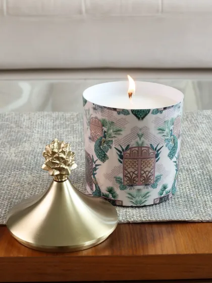 This scented candle features a unique architectural print, offering a more abstract and modern design. The gold pineapple lid adds our signature touch of luxe.